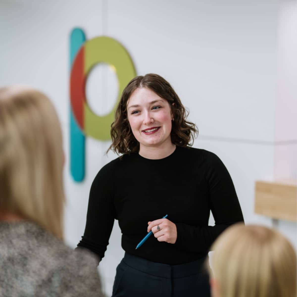 team member smiling with patient during visit