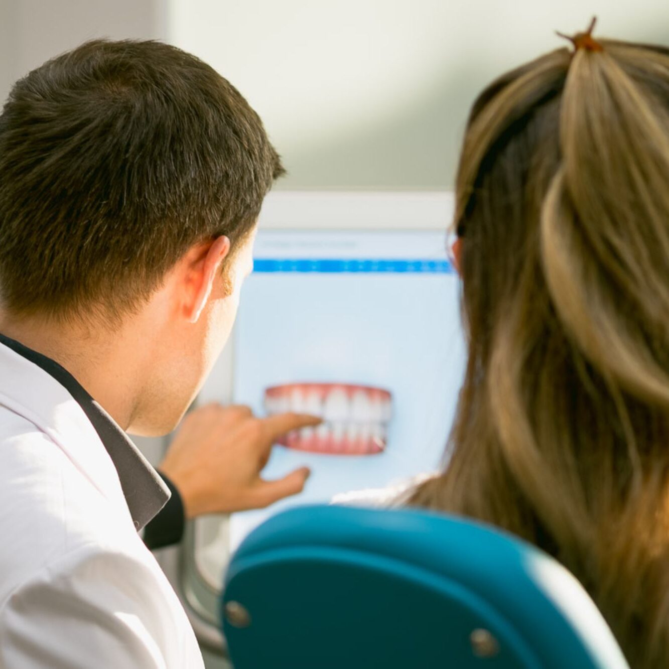 DSCF0120 Dentist discussing digital impression of teeth with patient, highlighting clear aligner treatment options at Paradigm Orthodontics.