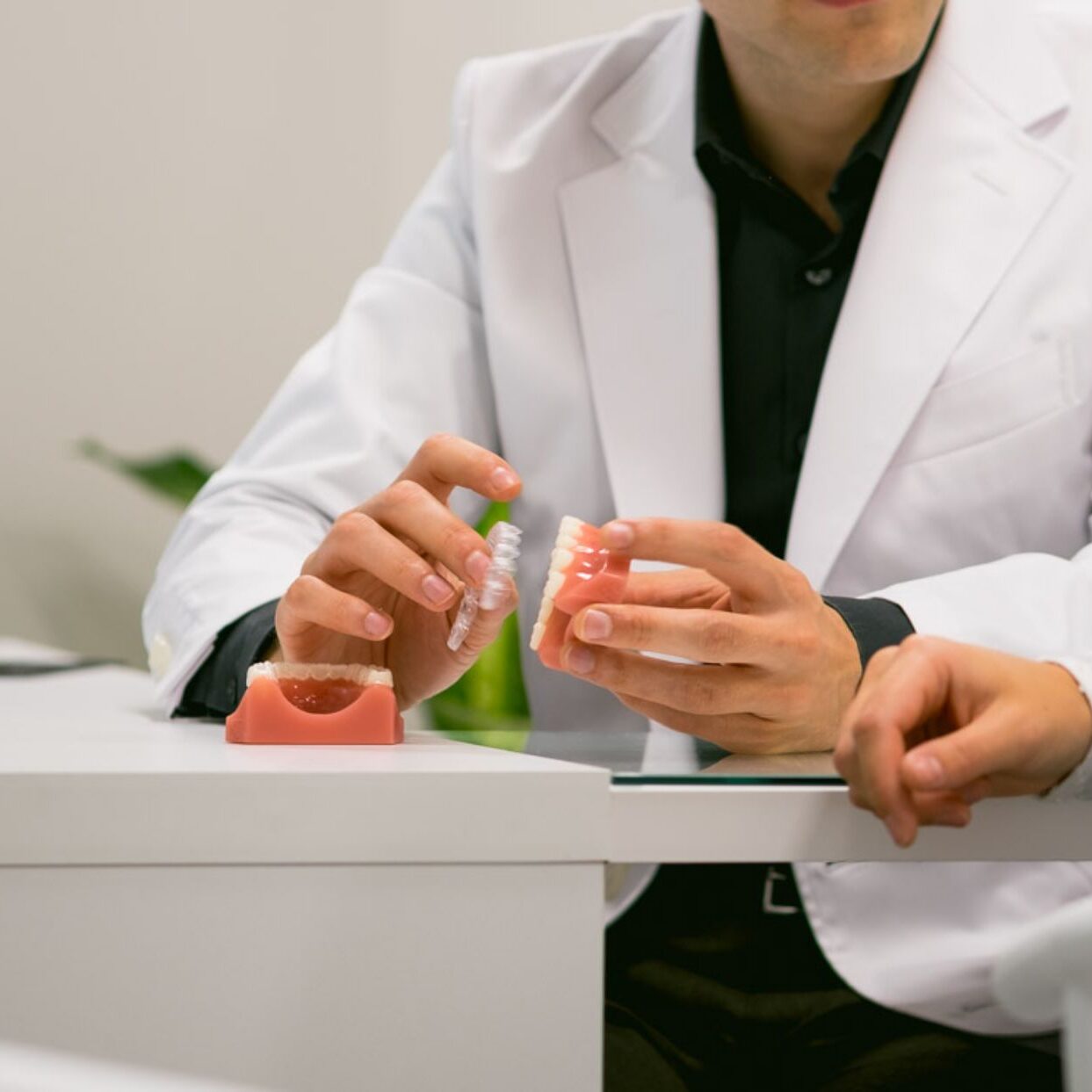 DSCF0223 Orthodontist demonstrating clear aligners and dental models during a consultation at Paradigm Orthodontics in Halifax.